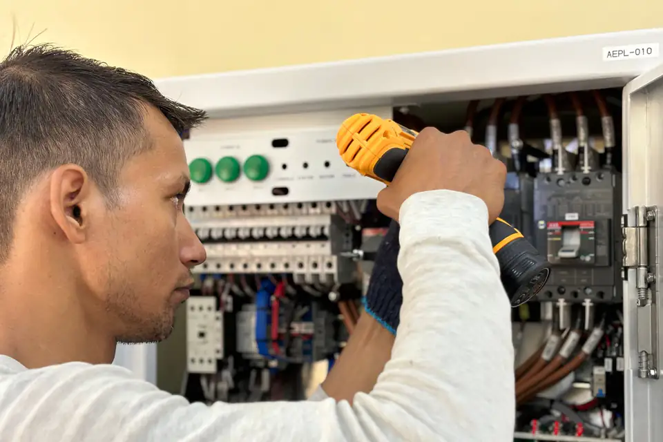 Electrician inspecting a residential electrical panel